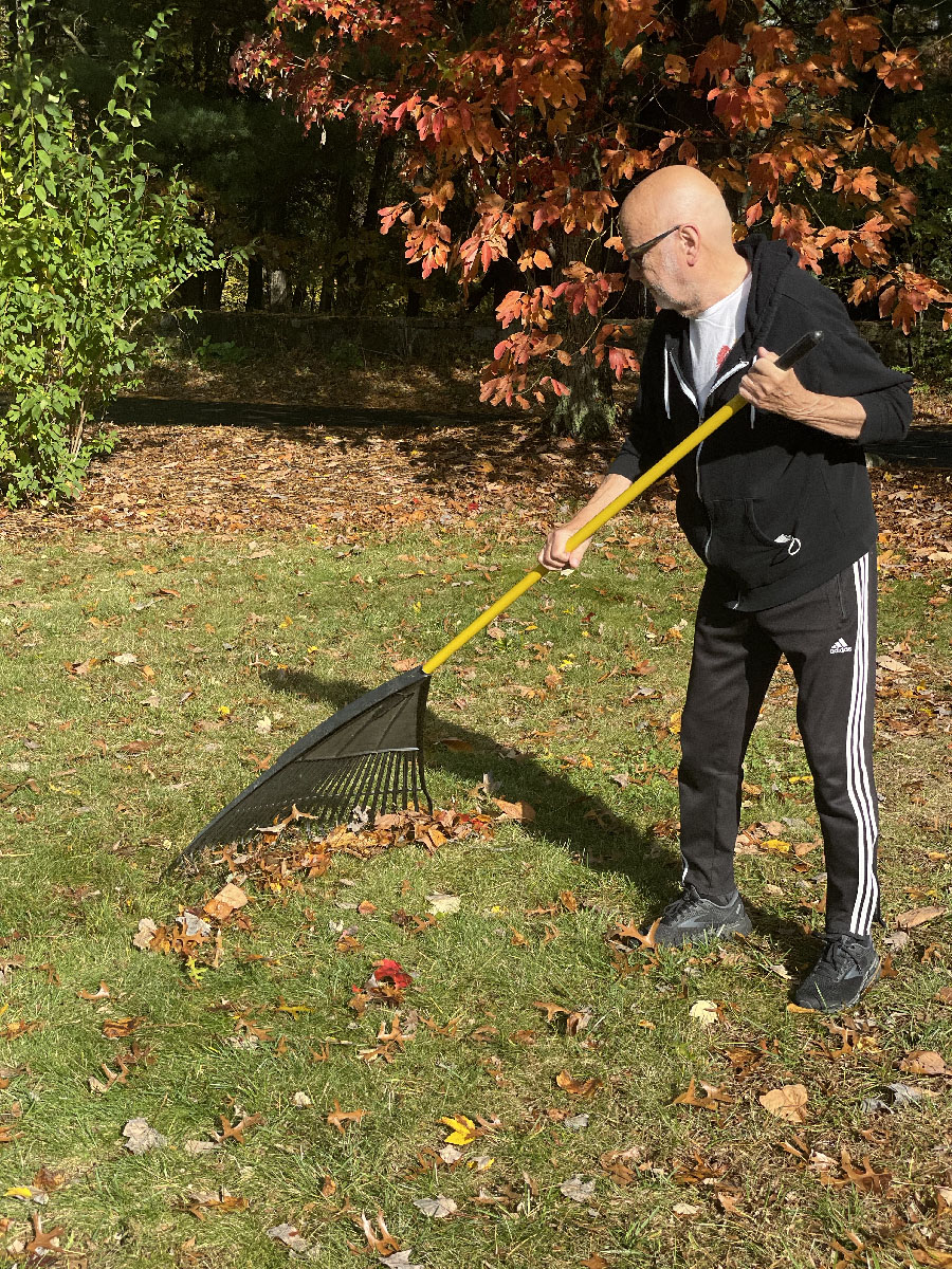 man raking leaves